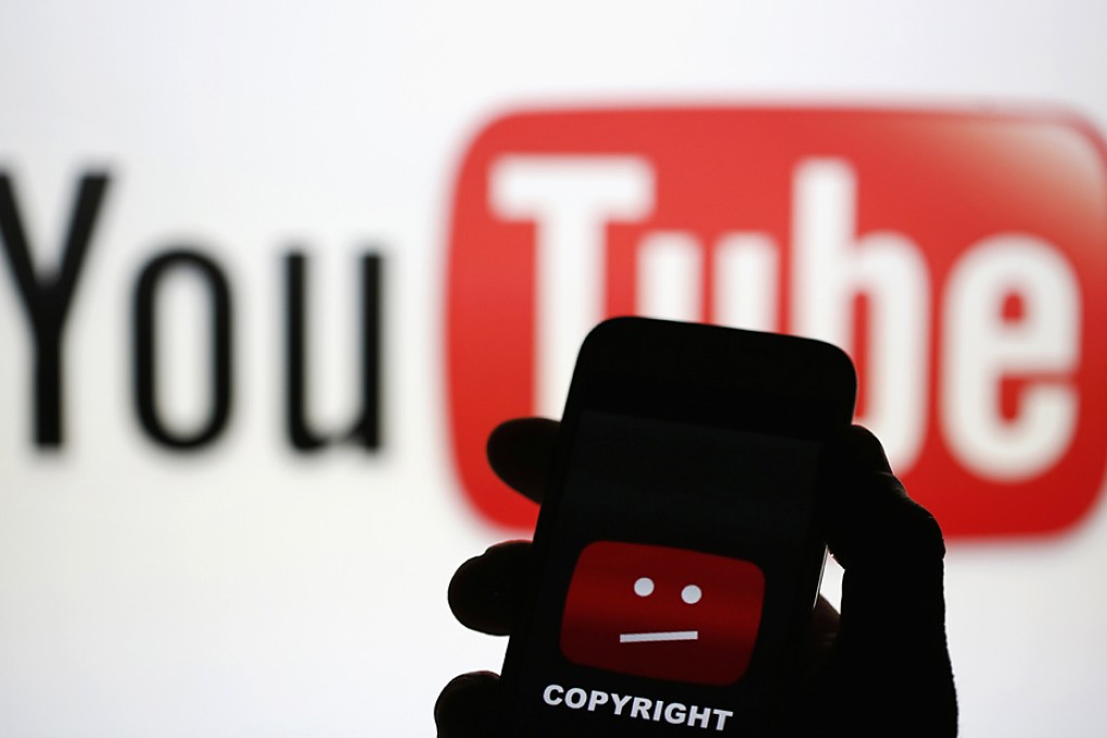 A picture illustration shows a photo taken of a YouTube error logo, displayed on a cell phone in front of a YouTube logo. Photo: Reuters