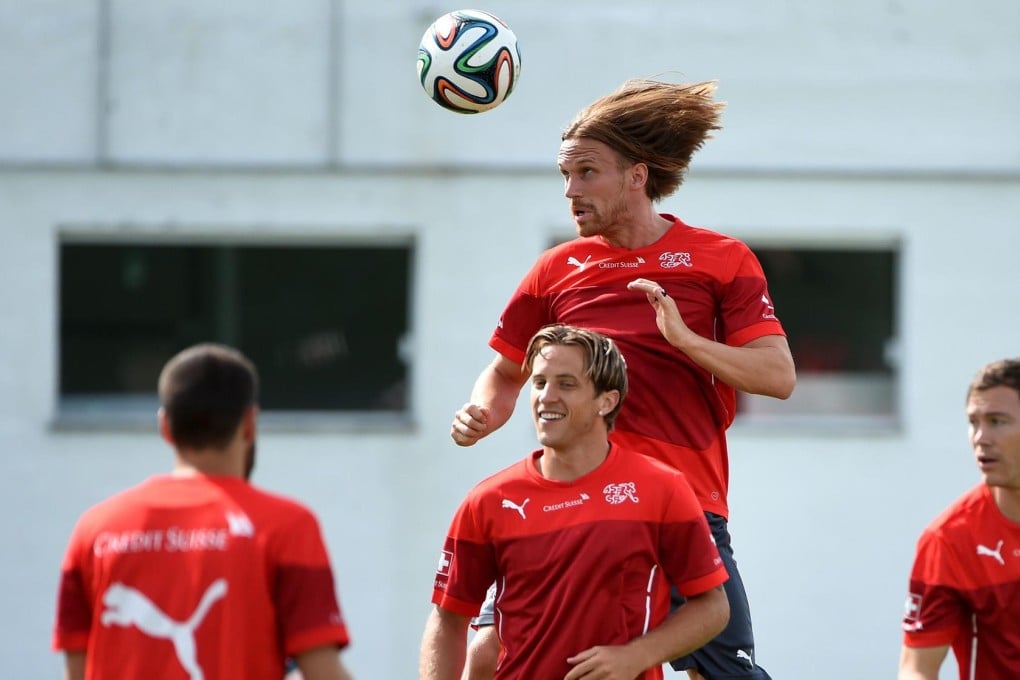 Switzerland's Michael Lang aims for a header in training. Photo: AFP