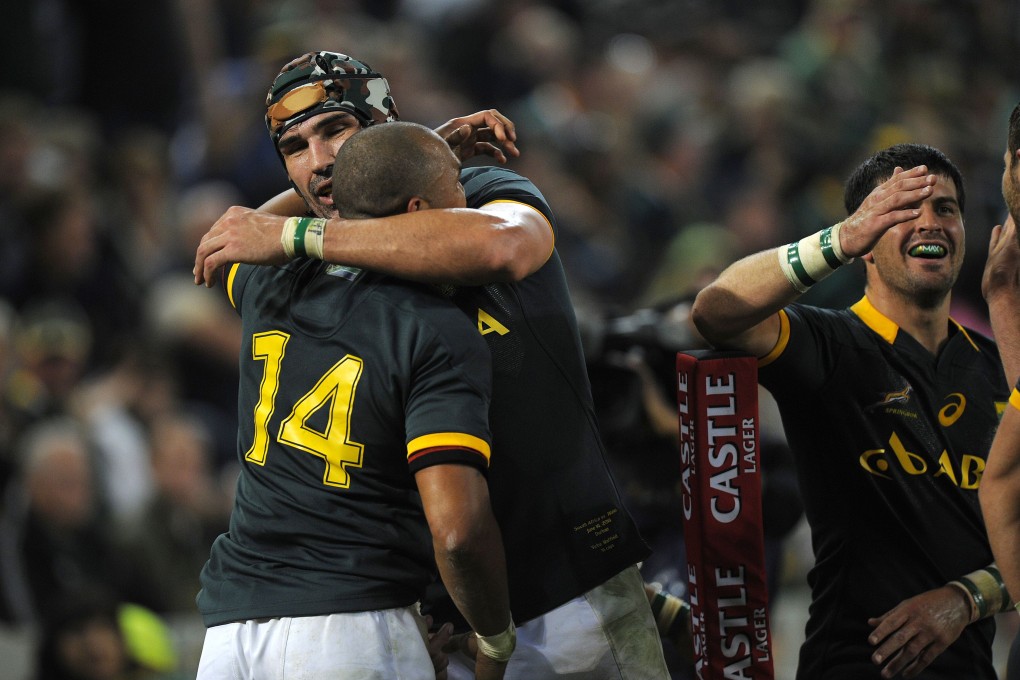 South African wing Cornal Hendricks (left) is embraced by Springboks skipper Victor Matfield after scoring against Wales in the first test. Photo: AFP