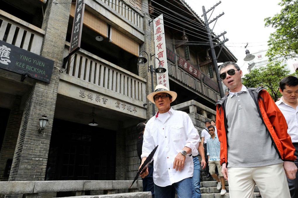 Feng Xiaogang (right) and Hong Kong's Jackie Chan tour the theme park and studio complex in Hainan.