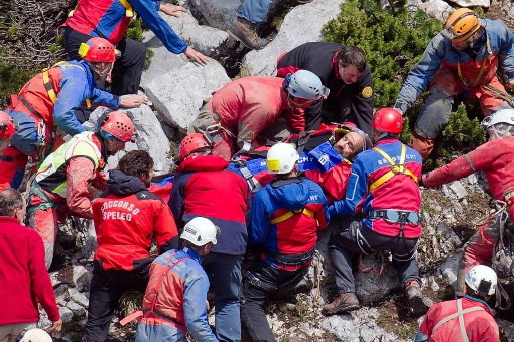 Rescue workers carry injured cave explorer Johann Westhauser on a stretcher near entrance to the Riesending cave after he was hauled up more than six kilometres of winding vents and narrow crevices. Photo: EPA