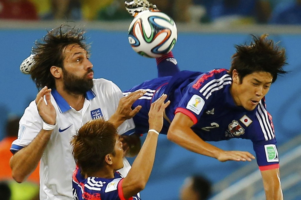 Japan's Atsuto Uchida is fouled by Greece's Giorgios Samaras during their group C stalemate at the Dunas arena in Natal. Photo: Reuters