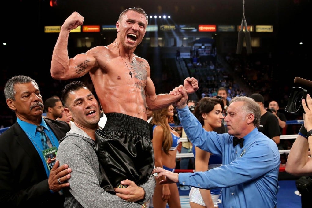 Vasyl Lomachenko celebrates his majority decision over American Gary Russell to win the WBO featherweight world crown. Photo: AFP