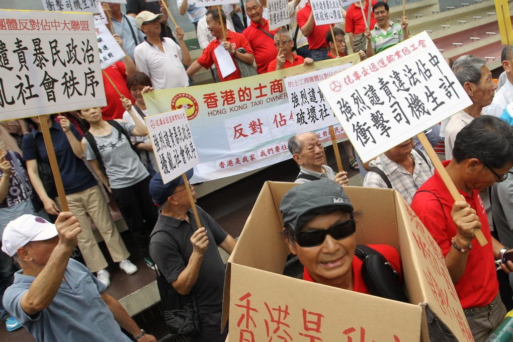 Members of an alliance of 20 taxi groups march to police headquarters to protest against the Occupy Central movement. Photo: Edward Wong