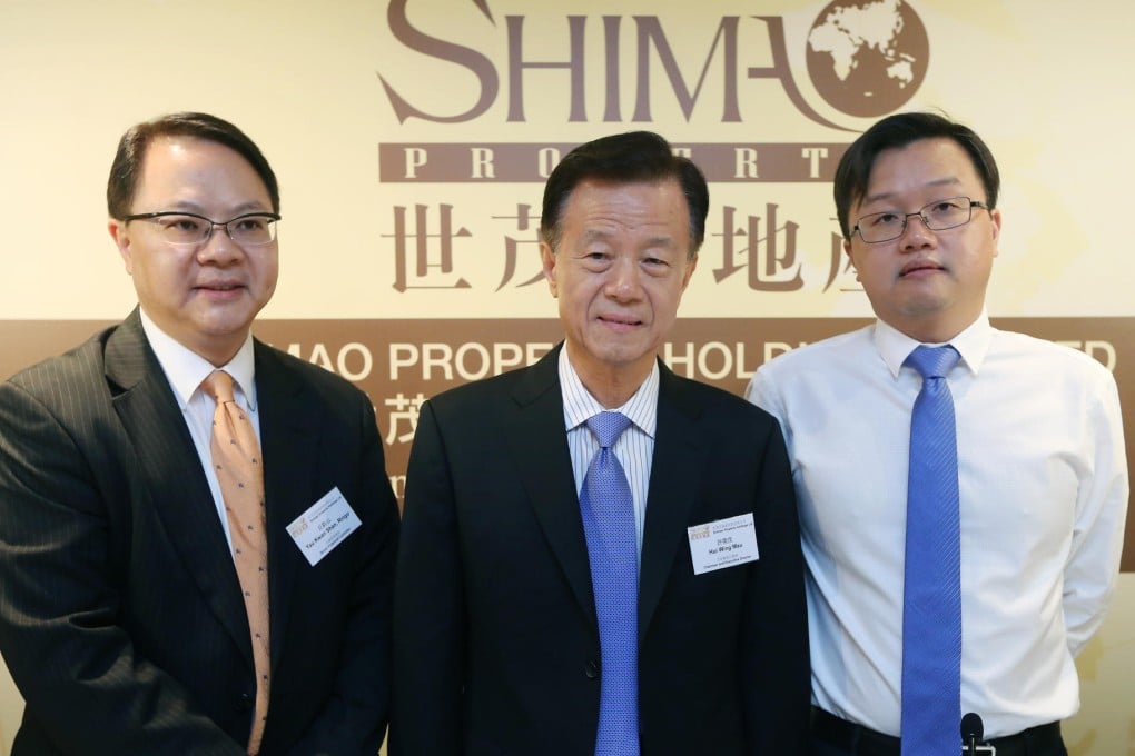 (Left to right) Shimao Property senior financial controller Ringo Yau, chairman Hui Wing-mau, and vice chairman Jason Hui, attend the company's AGM press conference in Wan Chai.