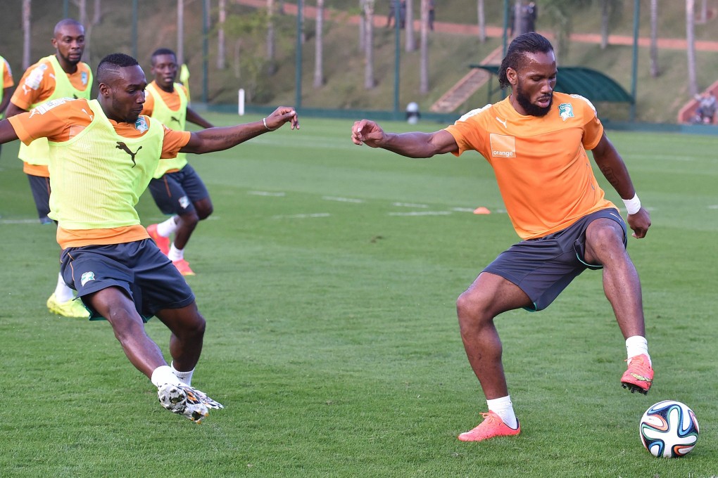 Ivory Coast's forward Didier Drogba (right) and defender Arthur Boka take part in training at Aguas de Lindoia. Photo: AFP