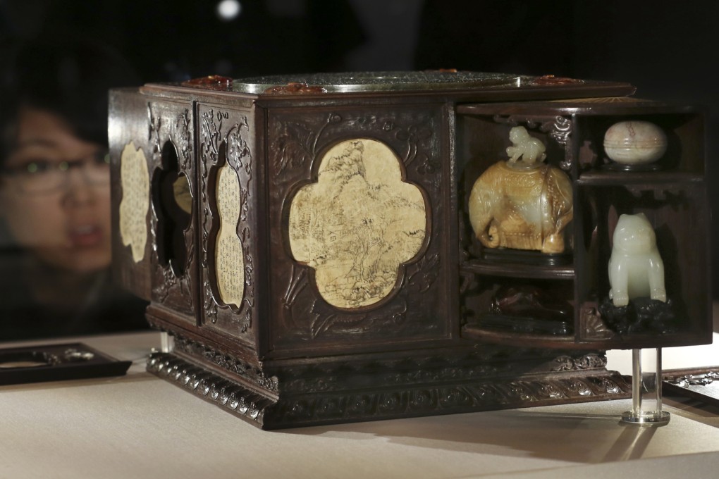 A woman views a square sandalwood curio box with multiple treasures of the Qing dynasty in a Tokyo museum; the artefact is among many borrowed from Taiwan for the exhibition. Photo: AP
