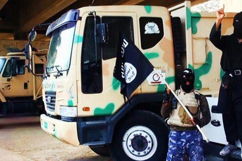 Jihadists from ISIL with vehicles taken from Iraqi forces. Photo: AFP