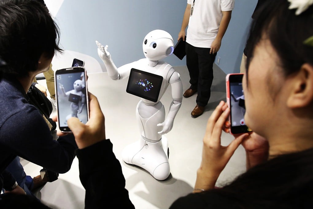 People take pictures with their mobile phones. The Japanese government is considering to impose a new tax on mobile phone owners. Photo: Reuters