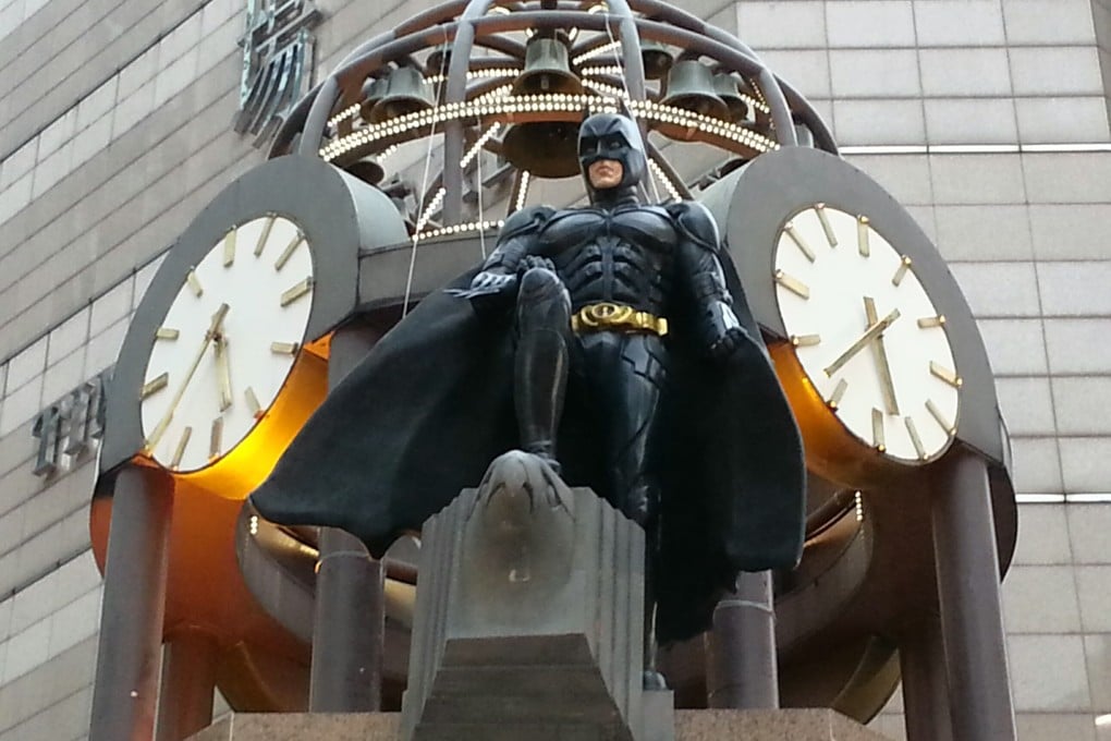 Batman stands above the clock tower in Causeway Bay. Photo: SCMP Pictures