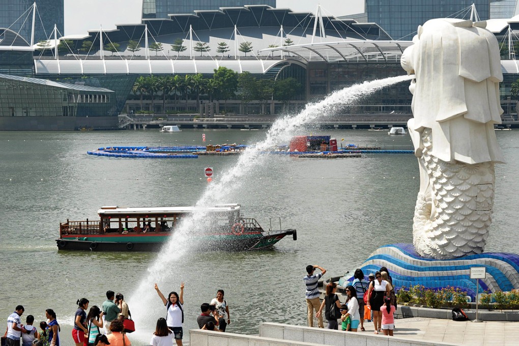 Tourists visit Merlion park in Singapore. Singapore is mounting a major tourism marketing drive in China. Photo: AFP