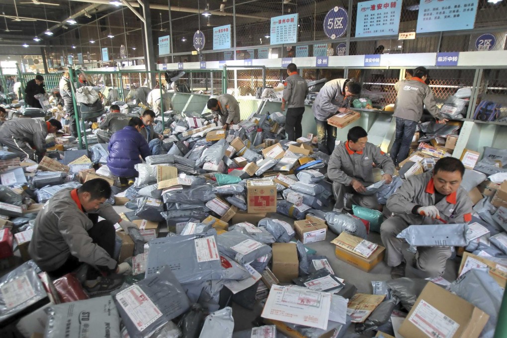 Packages are sorted at a mainland-based express delivery company. China South City expects income from e-commerce services to triple over the next three years. Photo: Reuters