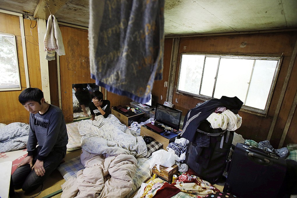 Two Chinese labourers under the Japanese internship programme in their living quarters in Hokota, Ibaraki prefecture. Photo: AP