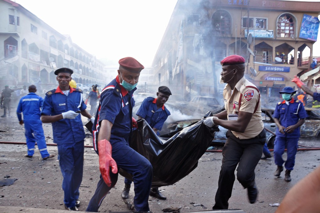 Rescue workers clear bodies after the mall explosion. Photo: AP