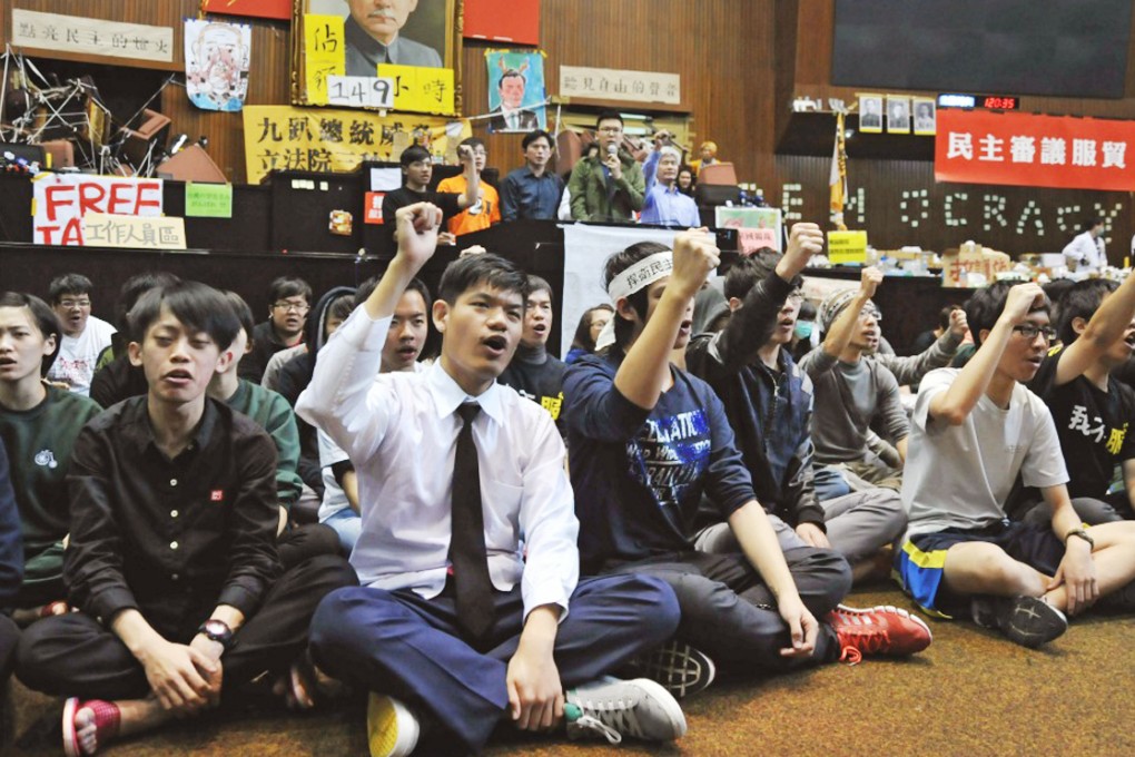 Students occupy the Legislative Yuan in March, including Lin Fei-fan (with microphone). Photo: AFP