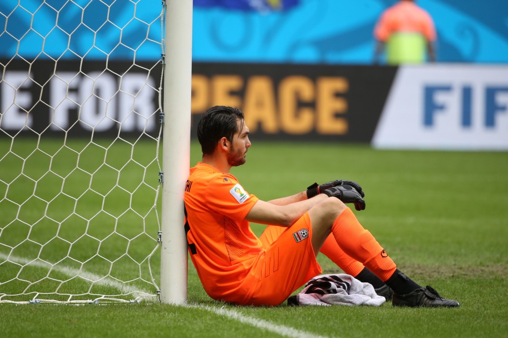 Iran's goalkeeper Alireza Haghighi reacts after their loss to Bosnia-Herzegovina at the Fonte Nova stadium in Salvador. Photo: Xinhua