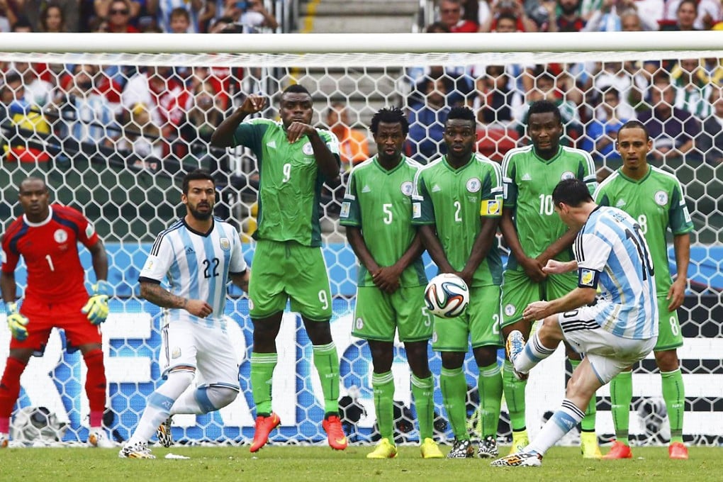 Argentina's Lionel Messi scores from a free kick over a wall of Nigerian players at the Beira Rio stadium in Porto Alegre. It is his fourth tournament goal. Photo: Reuters