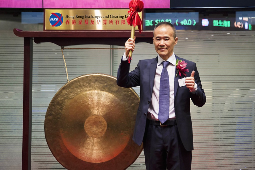 Vanke's Chairman Wang Shi reacts after hitting the gong during the debut of his company at the Hong Kong Stock Exchange on June 25, 2014. Photo: Reuters