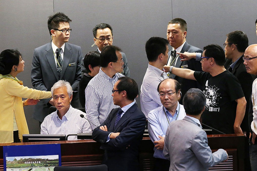 Lawmaker Leung Yiu-chung (seated) refuses to leave after the Finance Committee meeting descended into chaos last night. Photo: David Wong