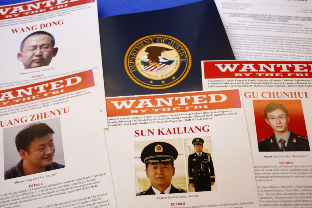 This May 19 file photo shows press material displayed at the Justice Department as charges of economic espionage and trade secret theft against five Chinese military officers, all hackers in an international cyberespionage case were announced. Photo: AP