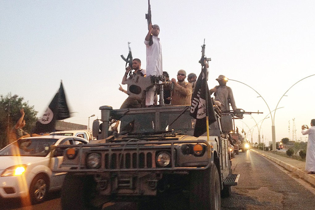 ISIL fighters parade a commandeered Iraqi tank in Mosul. Photo: AP