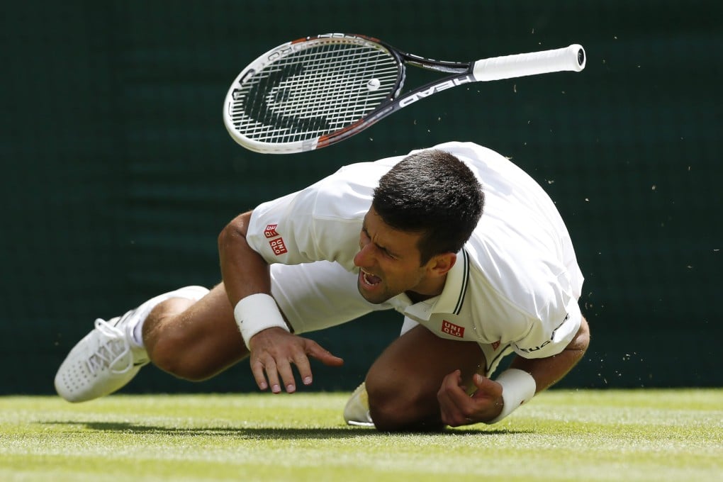 Novak Djokovic of Serbia takes a fall during the third set of his match against Gilles Simon of France. Photo: EPA