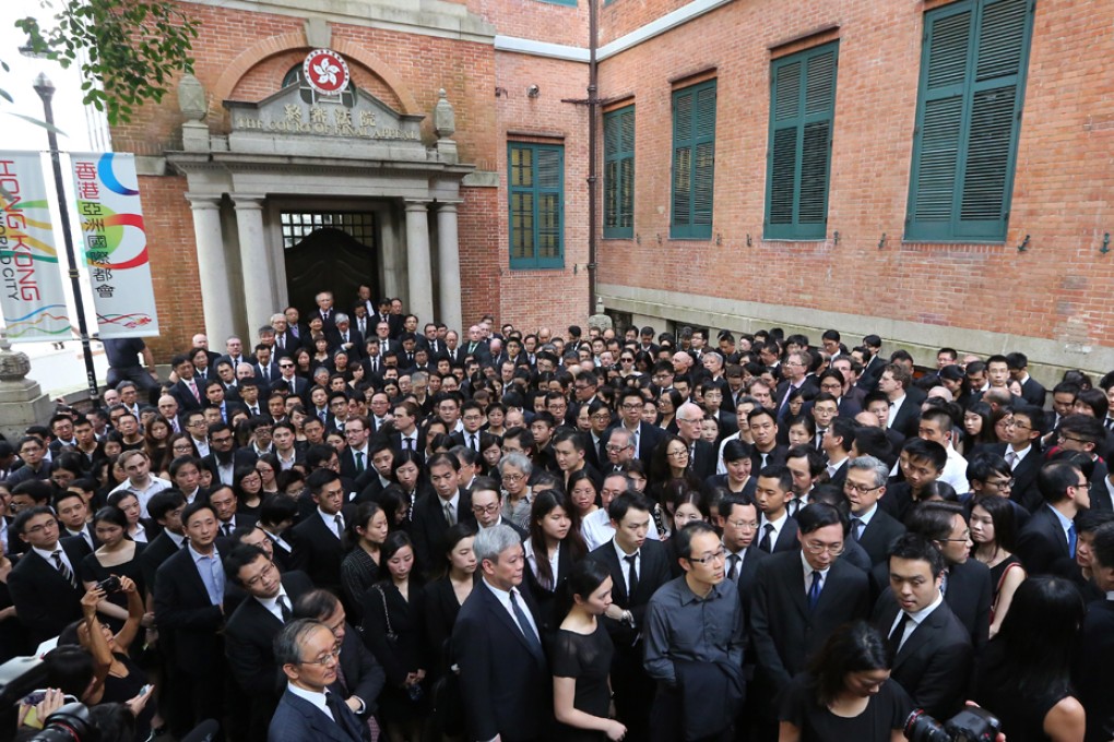 Hundreds of lawyers have marched silently on the streets of Central to protest against Beijing's recent White Paper.