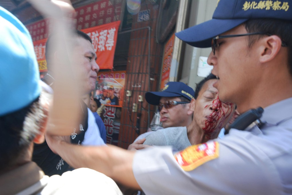 Taiwanese police try to stop a protest outside Lugang Mazu Temple, in Changhua county, targeting Zhang Zhijun. Photo: CNA