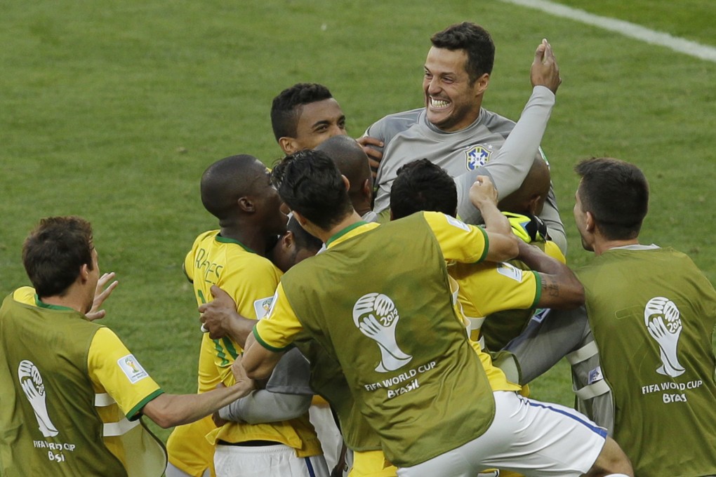 Brazil congratulate their goalkeeper Julio Cesar after reaching the quarter-finals. Photo: AP