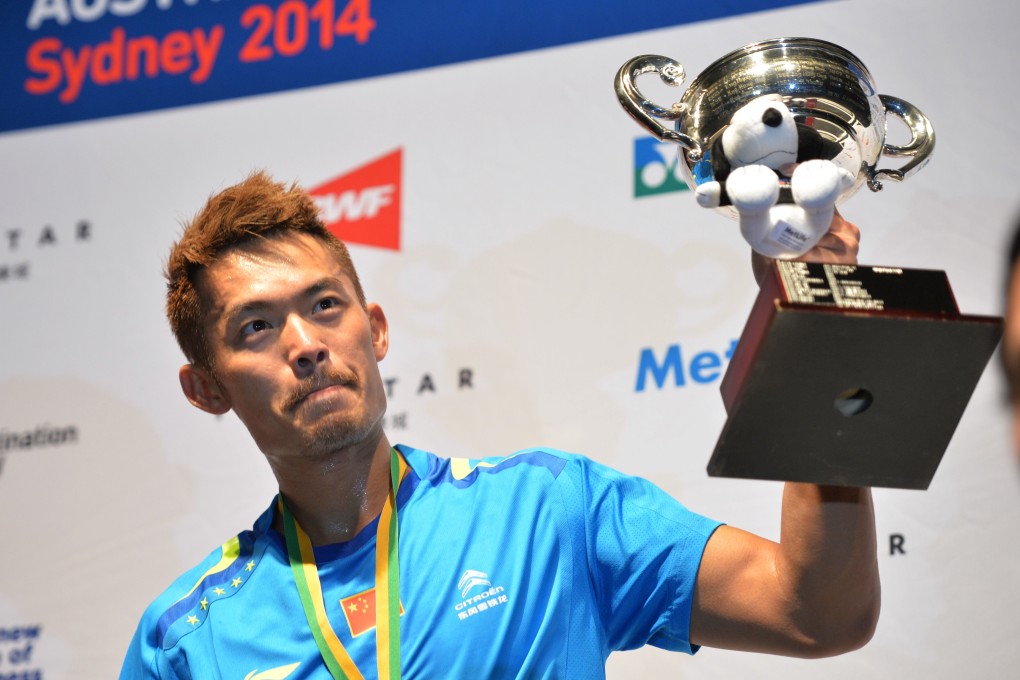 China's Lin Dan holds up the trophy after winning the men's singles final at the Australia Open. Photo: AFP