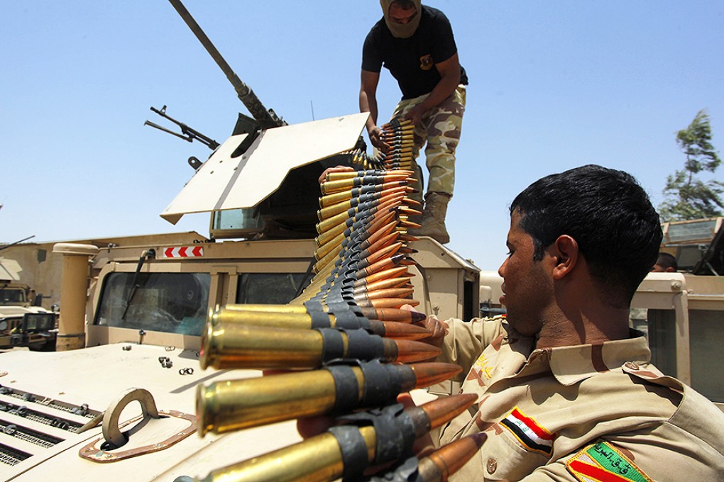 Iraqi soldiers load ammunition before departing for a patrol through the town of Jurf al-Sakhar. Photo: Reuters