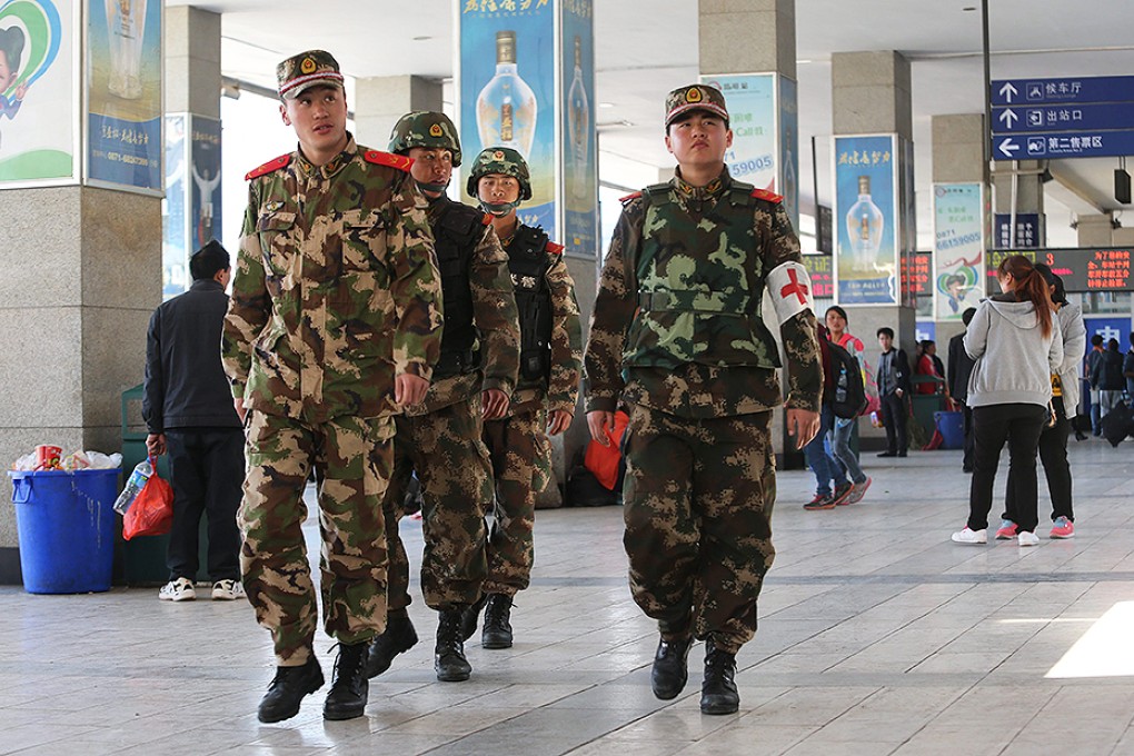 Paramilitary police patrol Kunming railway station in the wake of the attack. Photo: EPA