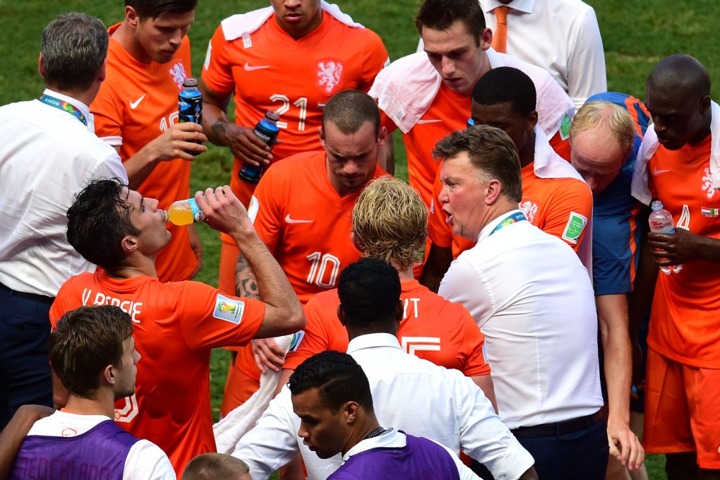 Louis van Gaal talks to his players during the drinks break. Photo: AFP