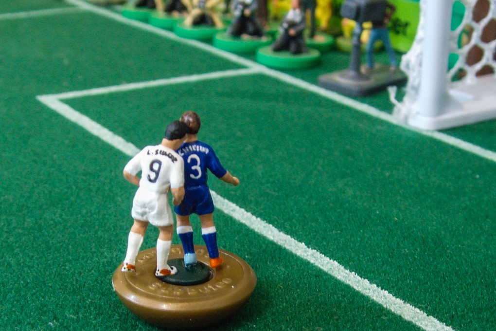 Subbuteo Luis Suarez bites Subbuteo Giorgio Chiellini. Photo: AFP