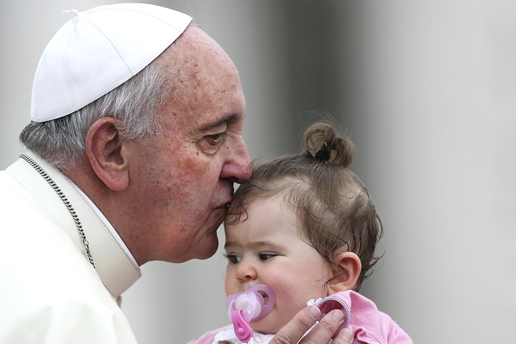 Pope Francis kisses a child during his general audience in Saint Peter's Square at the Vatican. Photo: Reuters
