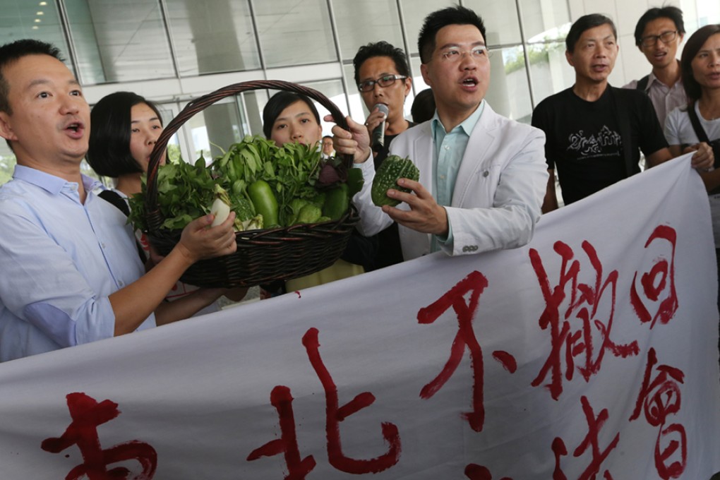 Residents affected by the new town development project presented their farm products to lawmakers Raymond Chan Chi-chuen and Gary Fan Kwok-wai in a petition to stop preliminary funding for the project.
