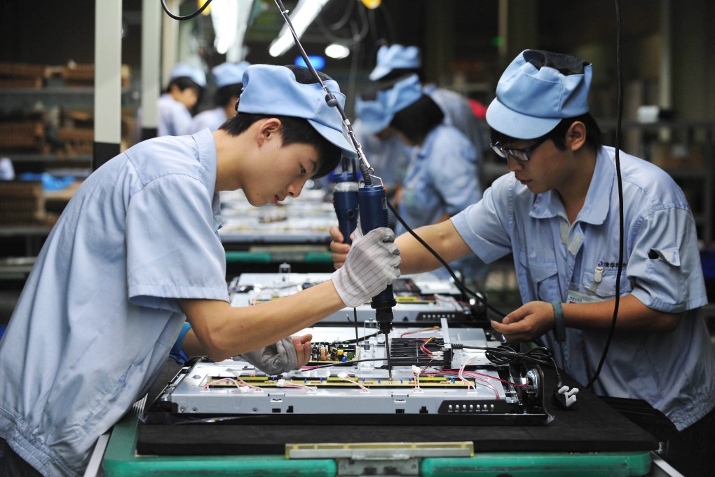 Young migrant workers labour on a television set assembly line in a factory in Shenyang, Liaoning Province. Photo: EPA