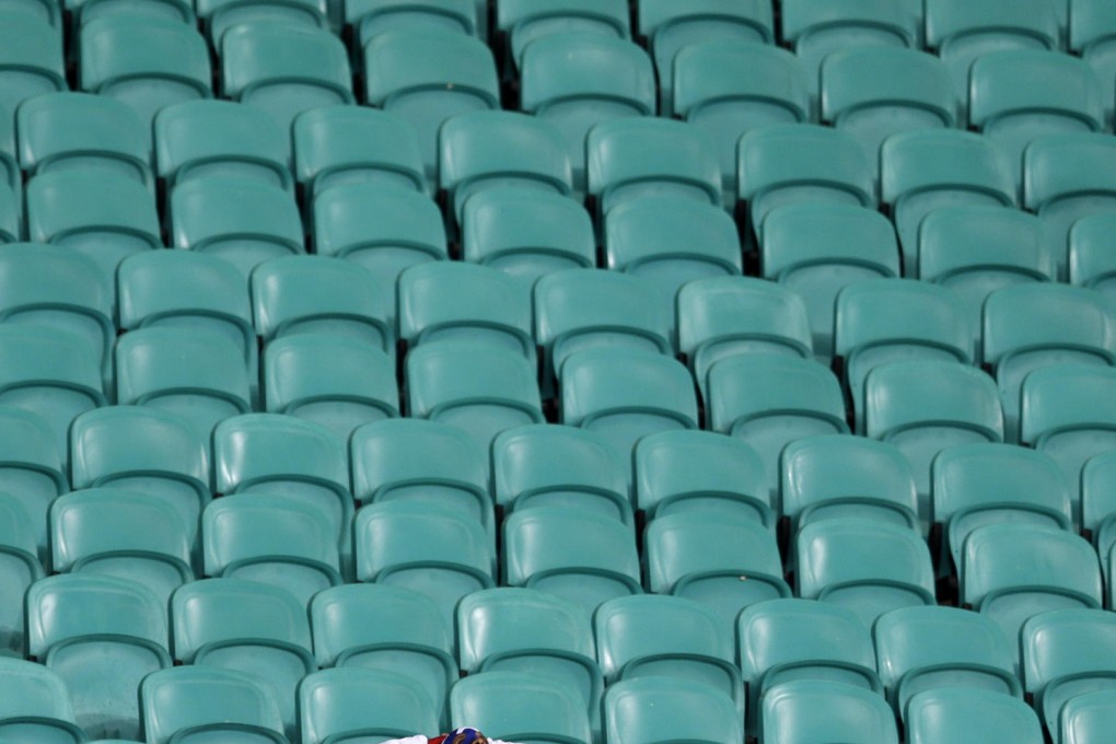 A lone US supporter in a Captain America costume is distraught at losing the battle after his team were beaten by Belgium. Photo: AP
