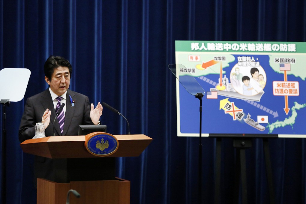 Japan's Prime Minister Shinzo Abe speaks next to a placard showing a defensive scenario for the protection of Japanese nationals overseas, during a news conference at his official residence in Tokyo. Photo: Reuters