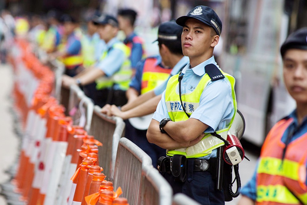 Police stand along the route of the July 1 march. Photo: Bloomberg