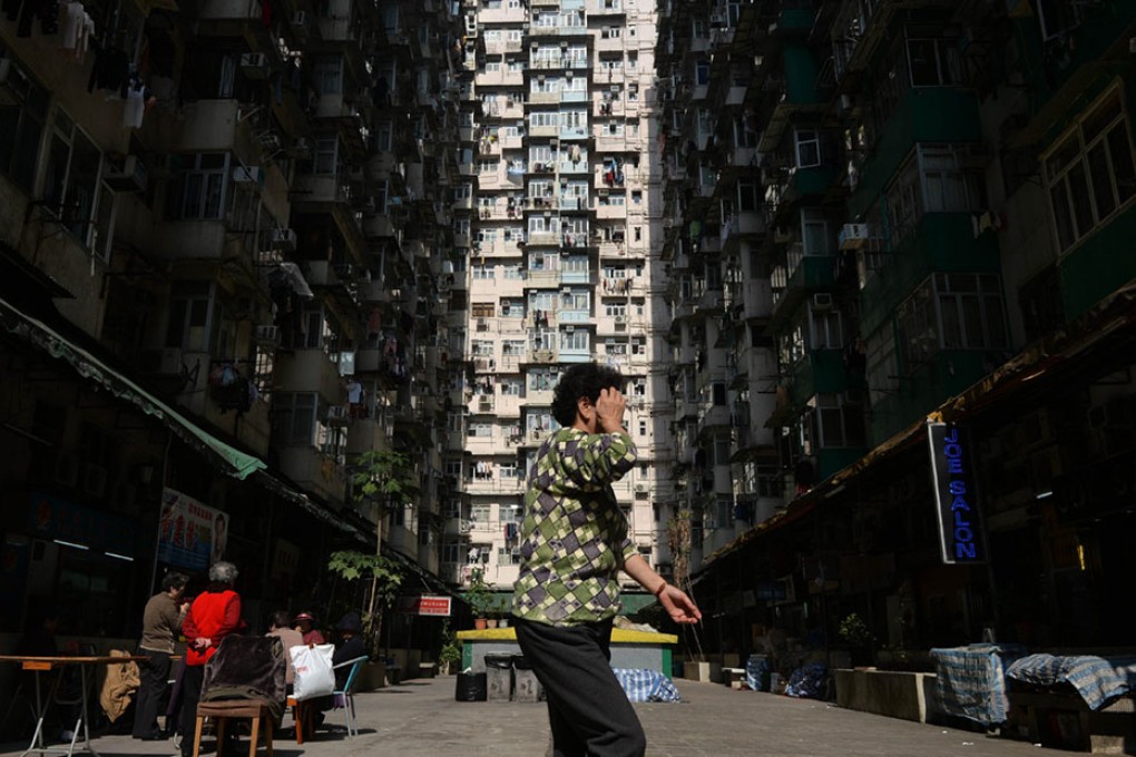 A woman walks through a residential estate in Hong Kong. When the divorce rate is rising, the measurement of household income inequality will be distorted. Photo: AFP