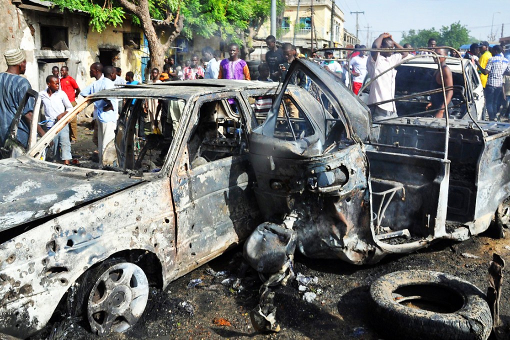 The bomb exploded in a market in Maiduguri, reducing stalls and goods to debris and leaving cars burned out. Photo: AFP