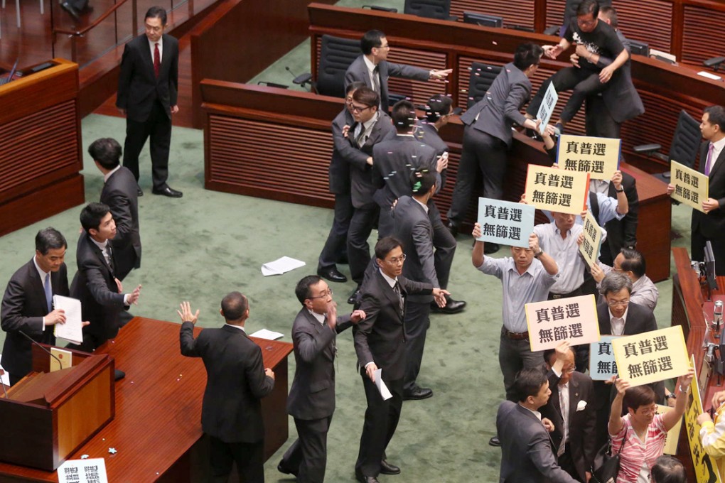 Lawmakers protest during the chief executive's question-and-answer session. Photo: K.Y. Cheng