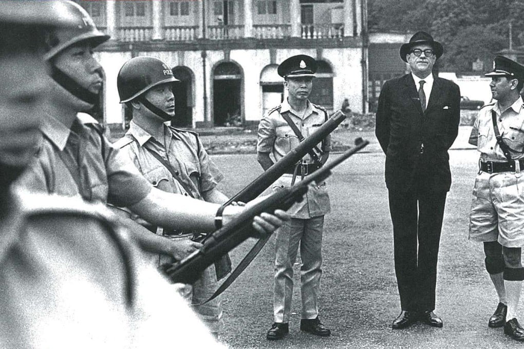 Governor David Trench inspects auxiliary police officers in the 1960s.