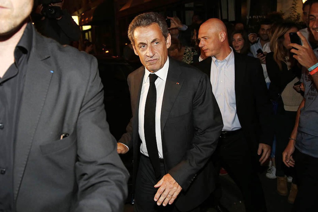 Former French President Nicolas Sarkozy leaves a restaurant in Paris on Wednesday. Photo: Reuters