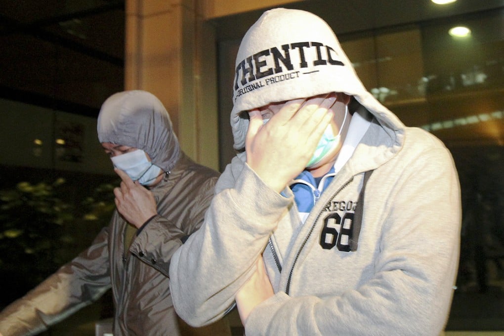 Two unidentified members of Happy Valley leave ICAC headquarters after facing questions over match-fixing. Photo: Nora Tam