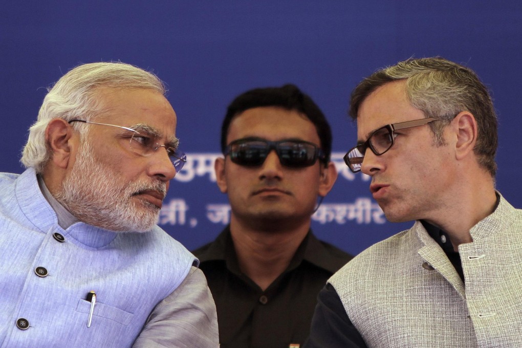 Kashmir's chief minister, Omar Abdullah (right), speaks with Modi after the prime minister inaugurated a new rail link. Photo: Reuters