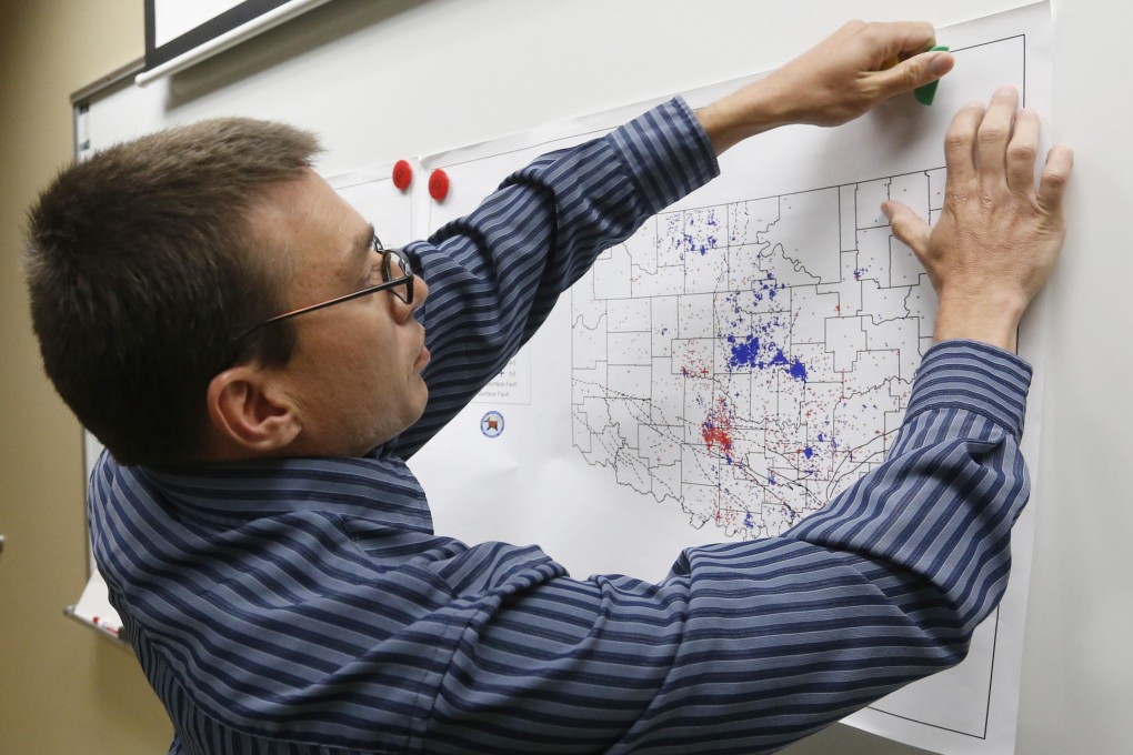 A seismologist with an Oklahoma earthquake map. Photo: AP
