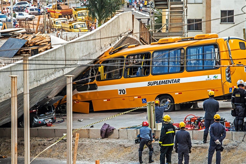 Firefighters and policemen work at the site where several vehicles were crushed by a viaduct that collapsed in Belo Horizonte. Photo: AFP