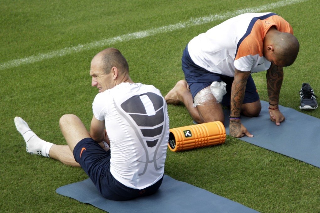 Arjen Robben (left) and Nigel de Jong do some stretching at the Netherlands' training base in Rio de Janeiro. Photo: AP